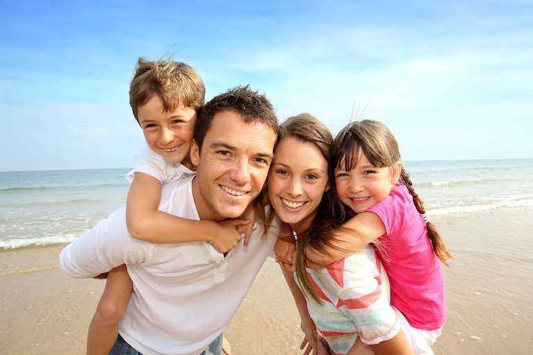 young family with happy smiles in fort lauderdale